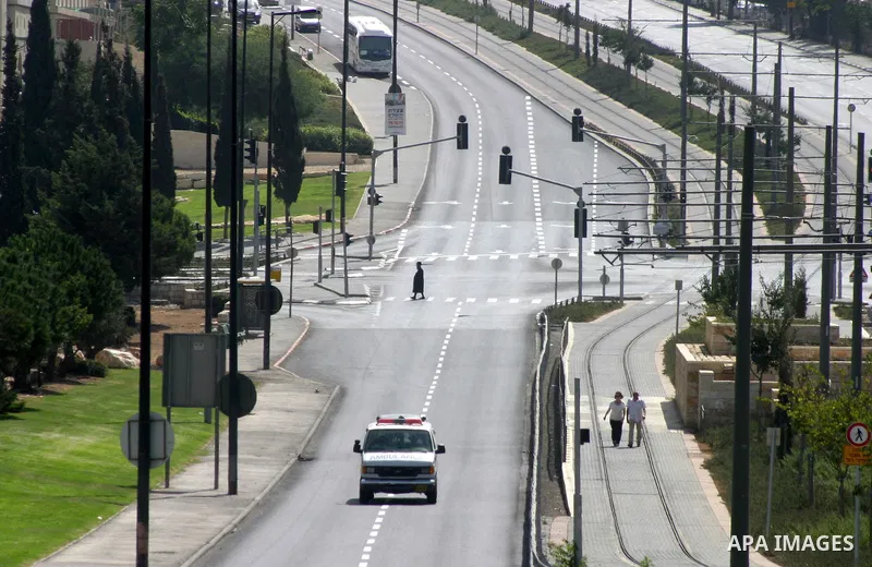 Israelis walks in the middle of an empty street during the Jewish holiday of Yom Kippur in Jerusalem, Saturday, Oct. 8, 2011. Yom Kippur, or "Day of Atonement," is the holiest of Jewish holidays when observant Jews atone...
