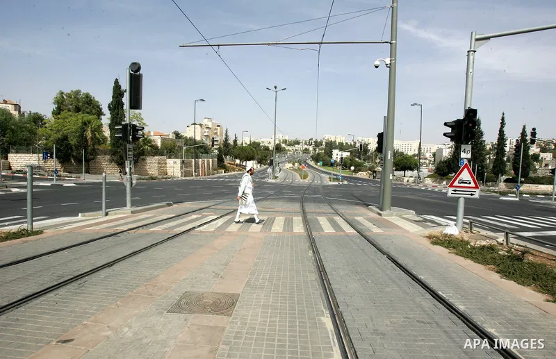 Israelis walks in the middle of an empty street during the Jewish holiday of Yom Kippur in Jerusalem, Saturday, Oct. 8, 2011. Yom Kippur, or "Day of Atonement," is the holiest of Jewish holidays when observant Jews atone...