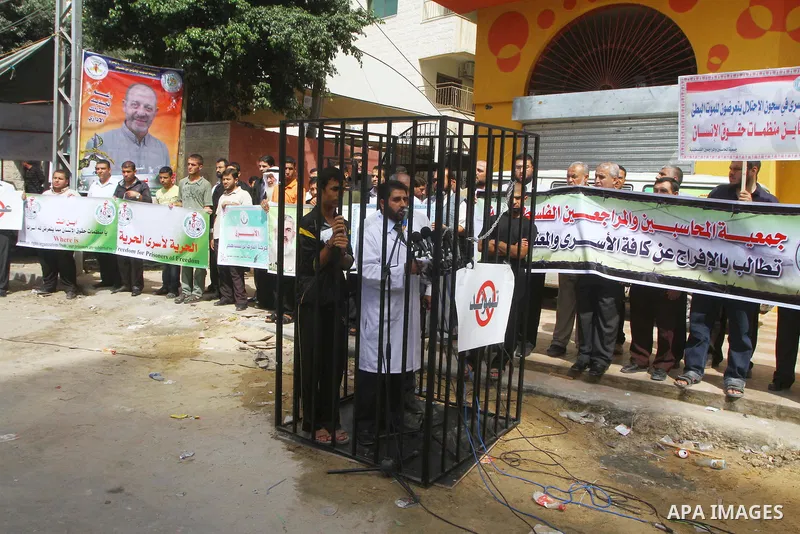 Palestinians take part in a protest in Gaza City Oct, 08, 2011, to show solidarity with Palestinian prisoners held in Israeli jails. Hundreds of Palestinians in Israeli jails have joined a hunger strike to protest agains...