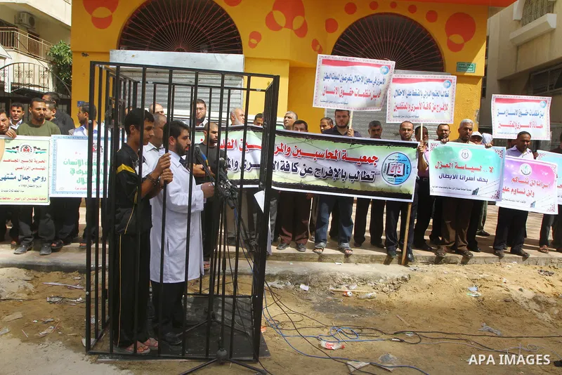Palestinians take part in a protest in Gaza City Oct, 08, 2011, to show solidarity with Palestinian prisoners held in Israeli jails. Hundreds of Palestinians in Israeli jails have joined a hunger strike to protest agains...