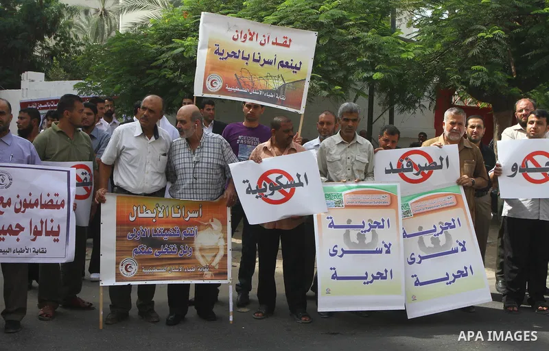 Palestinians take part in a protest in Gaza City Oct, 08, 2011, to show solidarity with Palestinian prisoners held in Israeli jails. Hundreds of Palestinians in Israeli jails have joined a hunger strike to protest agains...