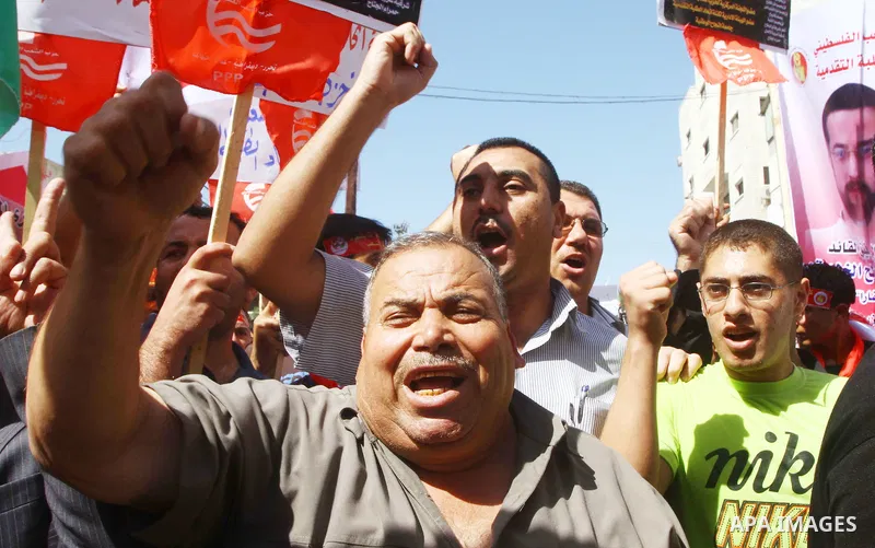 Palestinians shout during a demonstration calling for the release of prisoners from Israeli jails and in support of inmates on a hunger strike, on Oct,09, 2011, in Gaza City. Hundreds of Palestinians in Israeli jails hav...