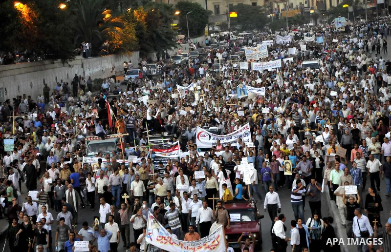 Egyptian Coptic Christians hold crosses and shout slogans, during a protest in Shubra, Cairo, 09 October 2011. According to media report, hundreds of Coptic Christians on 09 October, demonstrated outside the state televi...