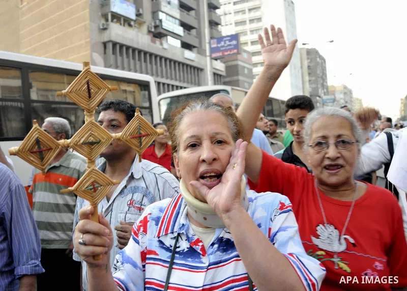 Egyptian Coptic Christians hold crosses and shout slogans, during a protest in Shubra, Cairo, 09 October 2011. According to media report, hundreds of Coptic Christians on 09 October, demonstrated outside the state televi...