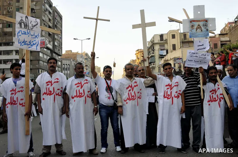 Egyptian Coptic Christians hold crosses and shout slogans, during a protest in Shubra, Cairo, 09 October 2011. According to media report, hundreds of Coptic Christians on 09 October, demonstrated outside the state televi...