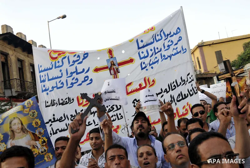Egyptian Coptic Christians hold crosses and shout slogans, during a protest in Shubra, Cairo, 09 October 2011. According to media report, hundreds of Coptic Christians on 09 October, demonstrated outside the state televi...