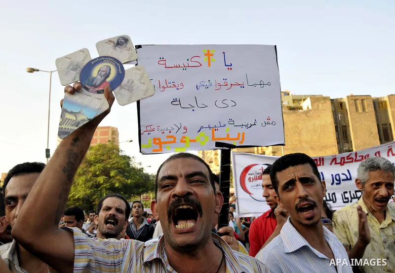 Egyptian Coptic Christians hold crosses and shout slogans, during a protest in Shubra, Cairo, 09 October 2011. According to media report, hundreds of Coptic Christians on 09 October, demonstrated outside the state televi...
