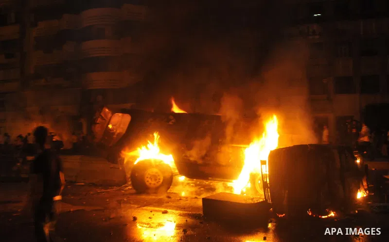Coptic Egyptian demonstrators gather by a burning army vehicle during cashes with Egyptian Army soldiers following a demonstration in Cairo, Egypt Sunday, Oct. 9, 2011. Egyptian state television reports at least one sold...