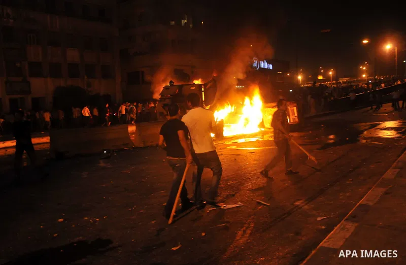 Coptic Egyptian demonstrators gather by a burning army vehicle during cashes with Egyptian Army soldiers following a demonstration in Cairo, Egypt Sunday, Oct. 9, 2011. Egyptian state television reports at least one sold...