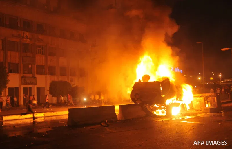 Coptic Egyptian demonstrators gather by a burning army vehicle during cashes with Egyptian Army soldiers following a demonstration in Cairo, Egypt Sunday, Oct. 9, 2011. Egyptian state television reports at least one sold...