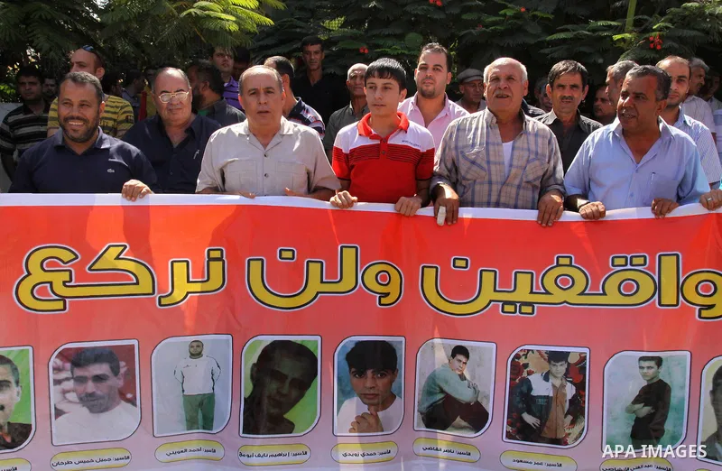 Palestinians protest during a demonstration calling for the release of prisoners from Israeli jails and in support of inmates on a hunger strike, on October 10, 2011, in Gaza City. Hundreds of Palestinians in Israeli jai...