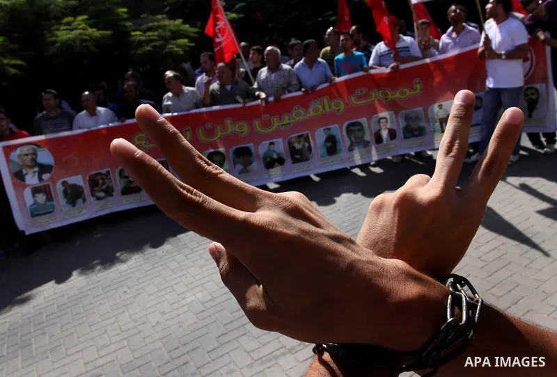 Palestinians protest during a demonstration calling for the release of prisoners from Israeli jails and in support of inmates on a hunger strike, on October 10, 2011, in Gaza City. Hundreds of Palestinians in Israeli jai...