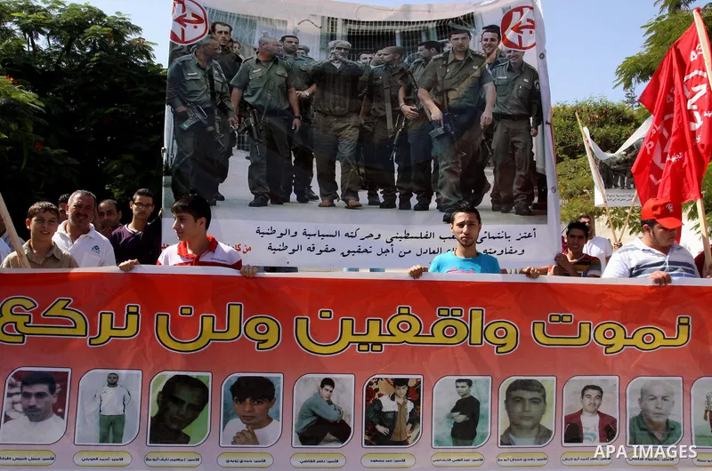 Palestinians protest during a demonstration calling for the release of prisoners from Israeli jails and in support of inmates on a hunger strike, on October 10, 2011, in Gaza City. Hundreds of Palestinians in Israeli jai...