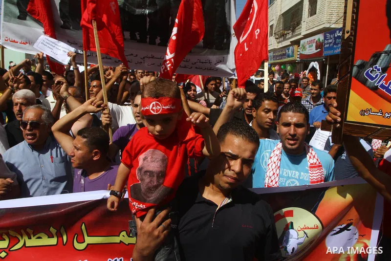 Palestinians take part in a protest in solidarity with Palestinian prisoners held in Israeli jails, in front of the International Red Cross building in Gaza City, Monday, Oct. 10, 2011. Gaza's Hamas rulers have imposed n...