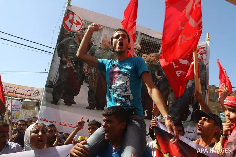 Palestinians take part in a protest in solidarity with Palestinian prisoners held in Israeli jails, in front of the International Red Cross building in Gaza City, Monday, Oct. 10, 2011. Gaza's Hamas rulers have imposed n...