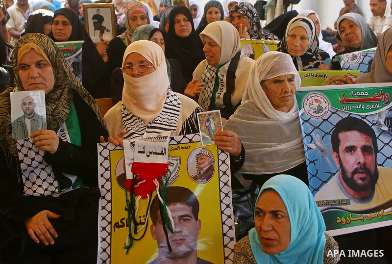 Palestinians take part in a protest in solidarity with Palestinian prisoners held in Israeli jails, in front of the International Red Cross building in Gaza City, Monday, Oct. 10, 2011. Gaza's Hamas rulers have imposed n...