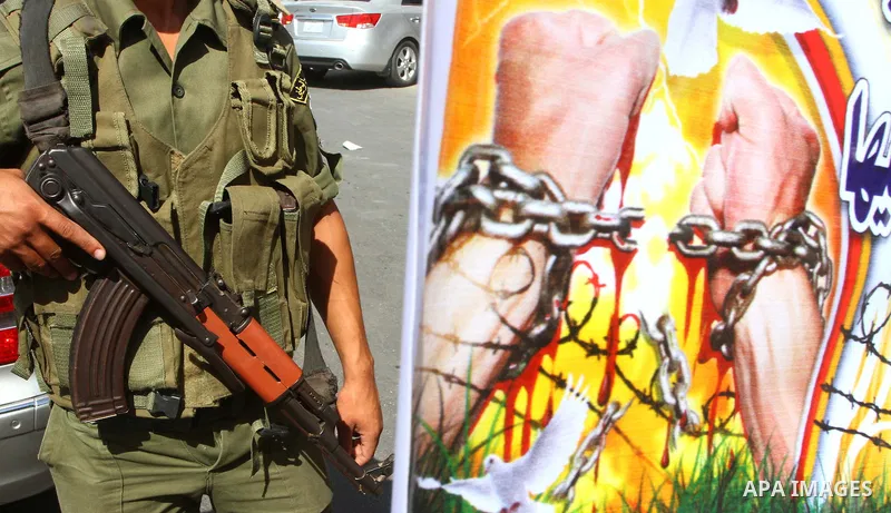 Palestinians take part in a protest in solidarity with Palestinian prisoners held in Israeli jails, in front of the International Red Cross building in Gaza City, Monday, Oct. 10, 2011. Gaza's Hamas rulers have imposed n...