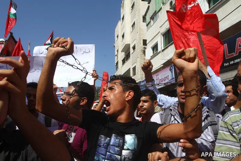 Palestinians take part in a protest in solidarity with Palestinian prisoners held in Israeli jails, in front of the International Red Cross building in Gaza City, Monday, Oct. 10, 2011. Gaza's Hamas rulers have imposed n...