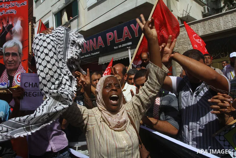 Palestinians take part in a protest in solidarity with Palestinian prisoners held in Israeli jails, in front of the International Red Cross building in Gaza City, Monday, Oct. 10, 2011. Gaza's Hamas rulers have imposed n...