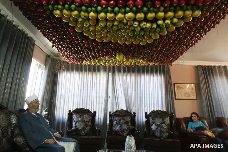 A man from the ancient Samaritan community decorates a Sukkah made from fresh fruit for the holiday of the Tabernacles, or Sukkot, in Mount Gerizim near the West Bank town of Nablus, Monday, Oct. 10, 2011. The Sukkah is...