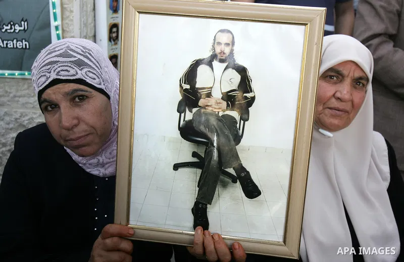 Palestinians take part in a protest in solidarity with their relatives Palestinian prisoners held in Israeli jails in a protest tent in front of the Red Cross' offices in east Jerusalem, on October 10, 2011. Thousands of...
