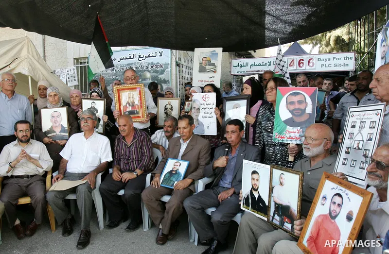 Palestinians take part in a protest in solidarity with their relatives Palestinian prisoners held in Israeli jails in a protest tent in front of the Red Cross' offices in east Jerusalem, on October 10, 2011. Thousands of...