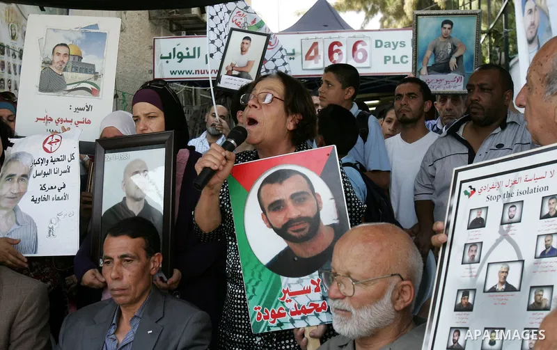 Palestinians take part in a protest in solidarity with their relatives Palestinian prisoners held in Israeli jails in a protest tent in front of the Red Cross' offices in east Jerusalem, on October 10, 2011. Thousands of...