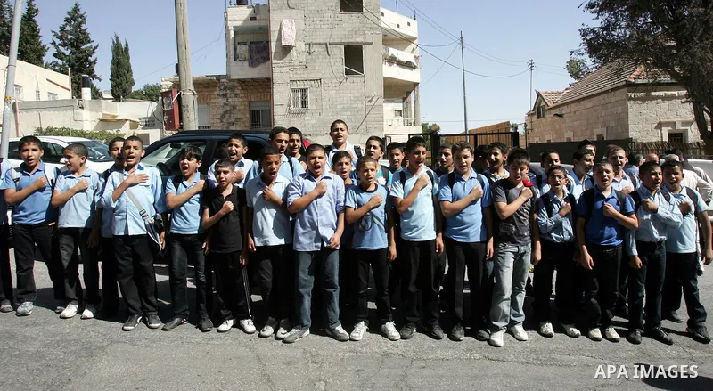 Palestinian schoolboys take part in a protest in solidarity with Palestinian prisoners held in Israeli jails in a protest tent in front of the Red Cross' offices in east Jerusalem, on October 10, 2011. Thousands of Pales...