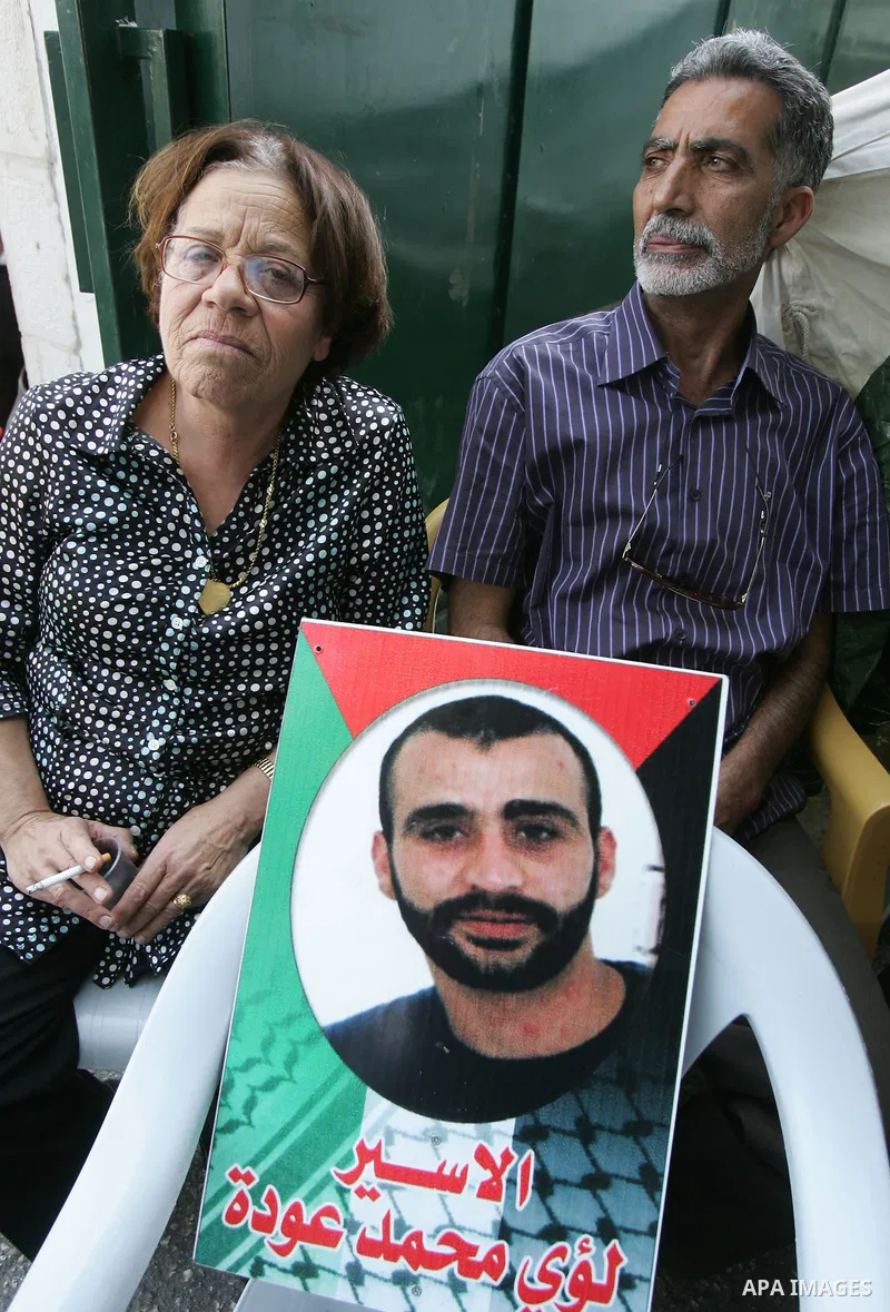 Palestinians take part in a protest in solidarity with their relatives Palestinian prisoners held in Israeli jails in a protest tent in front of the Red Cross' offices in east Jerusalem, on October 10, 2011. Thousands of...