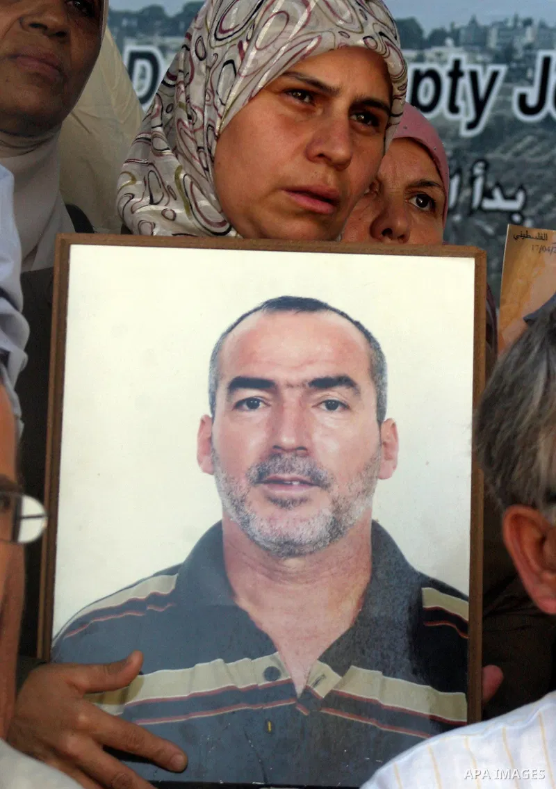 Palestinians take part in a protest in solidarity with their relatives Palestinian prisoners held in Israeli jails in a protest tent in front of the Red Cross' offices in east Jerusalem, on October 10, 2011. Thousands of...