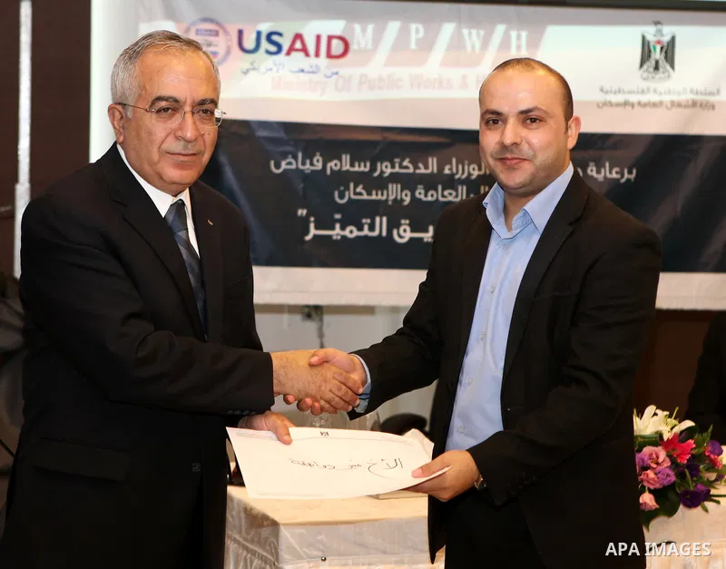 Palestinian prime minister Salam Fayyad attends a celebration to honor the staff of the Ministry of Public Works in the West Bank city of Ramallah, on October 10, 2011. Photo by Mustafa Abu Dayeh