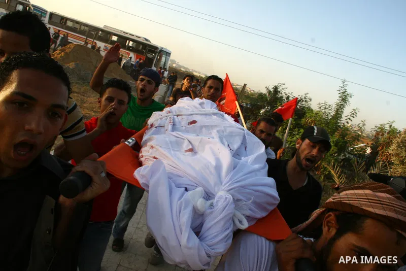 Palestinian mourners carry the body of Ahmed Azazmeh, killed in an explosion, during his funeral in Beit Hanoun, near the Erez Crossing between Gaza Strip and Israel, Monday, Oct. 10, 2011. Palestinian officials in the G...