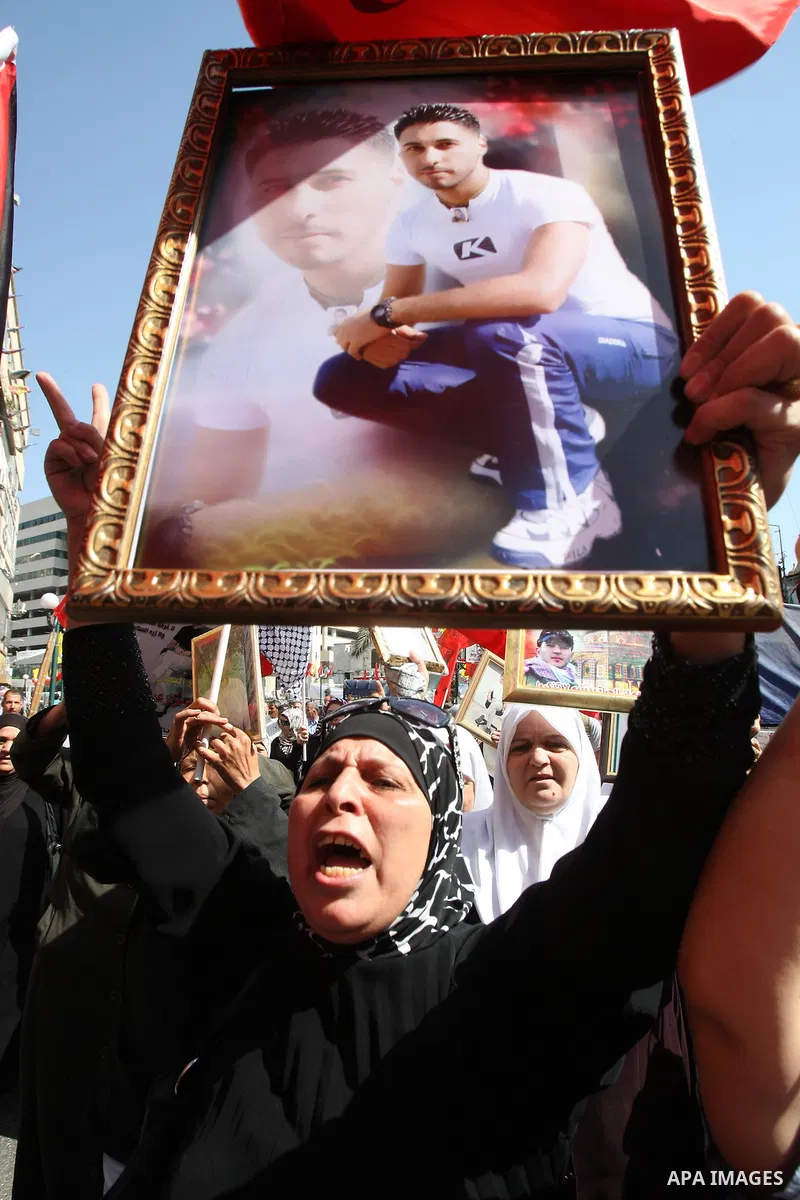 Palestinians participate in a demonstration in solidarity with prisoners jailed in Israel, in the West Bank city of Nablus, Oct. 11, 2011. According to the Israeli Prison Service spokesman, over 200 Palestinian prisoners...