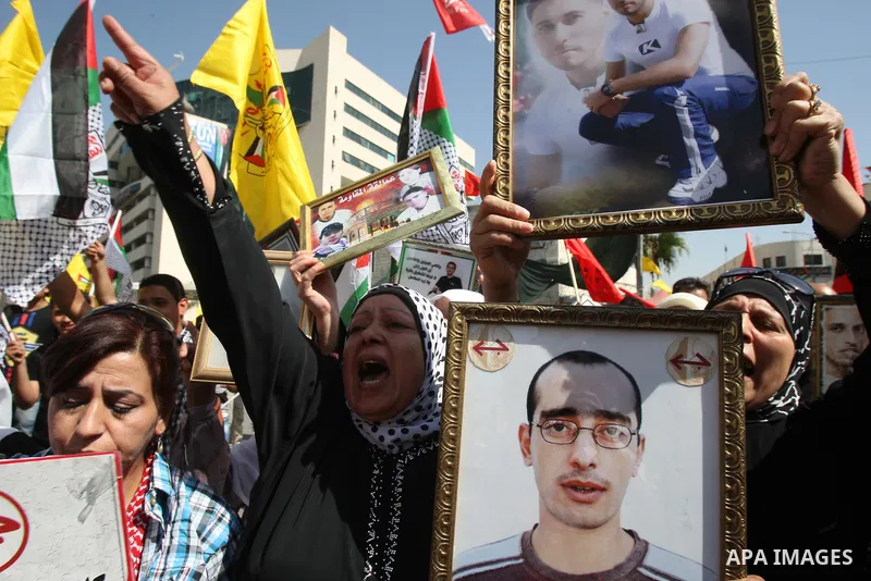Palestinians participate in a demonstration in solidarity with prisoners jailed in Israel, in the West Bank city of Nablus, Oct. 11, 2011. According to the Israeli Prison Service spokesman, over 200 Palestinian prisoners...