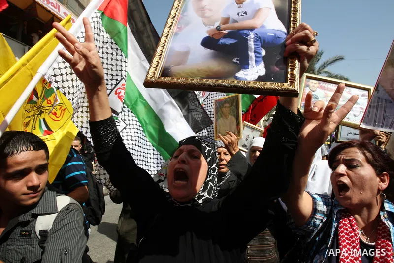 Palestinians participate in a demonstration in solidarity with prisoners jailed in Israel, in the West Bank city of Nablus, Oct. 11, 2011. According to the Israeli Prison Service spokesman, over 200 Palestinian prisoners...