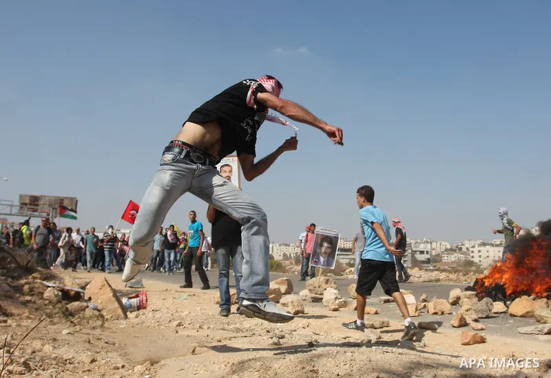 A Palestinian protestor clashes with Israeli forces following a demonstration calling for the release of prisoners held in Israeli jails and in support of inmates in hunger strike, on October 11, 2011 near Israel's Ofer...