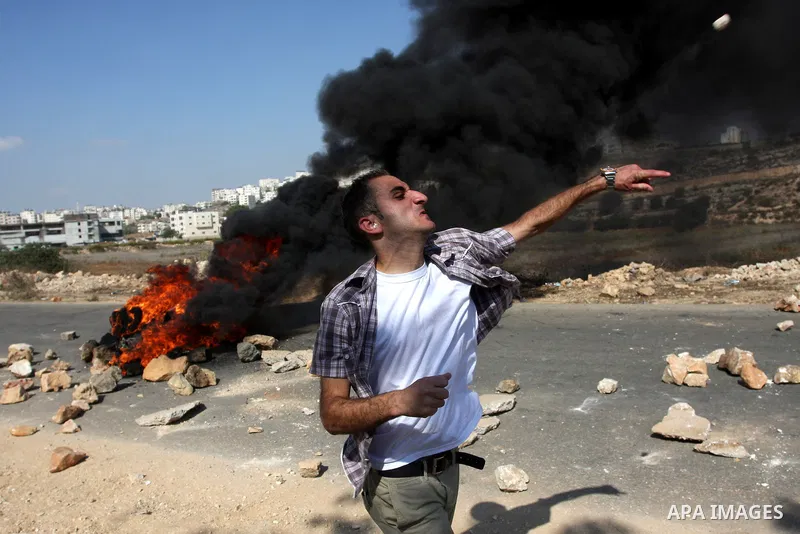 A Palestinian protestor clashes with Israeli forces following a demonstration calling for the release of prisoners held in Israeli jails and in support of inmates in hunger strike, on October 11, 2011 near Israel's Ofer...