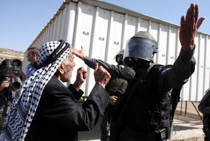 An Israeli soldier argues with a Palestinian man during a demonstration calling for the release of prisoners held in Israeli jails and in support of inmates in hunger strike, on October 11, 2011 near Israel's Ofer prison...