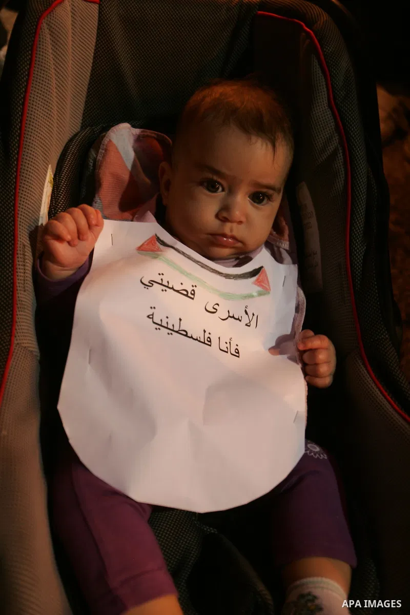 A Palestinian boy take part in a protest calling for the release of Palestinian prisoners from Israeli jails and in support of inmates in hunger strike on October 11, 2011 outside Damascus Gate in Jerusalem's Old City. A...
