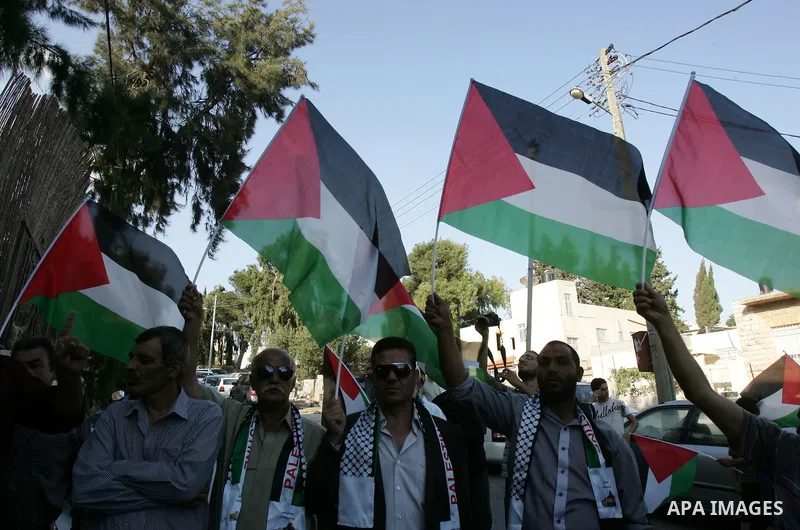 Palestinians take part in a protest calling for the release of Palestinian prisoners from Israeli jails and in support of inmates in hunger strike on October 11, 2011 outside the Red Cross buildings in Jerusalem's Old Ci...