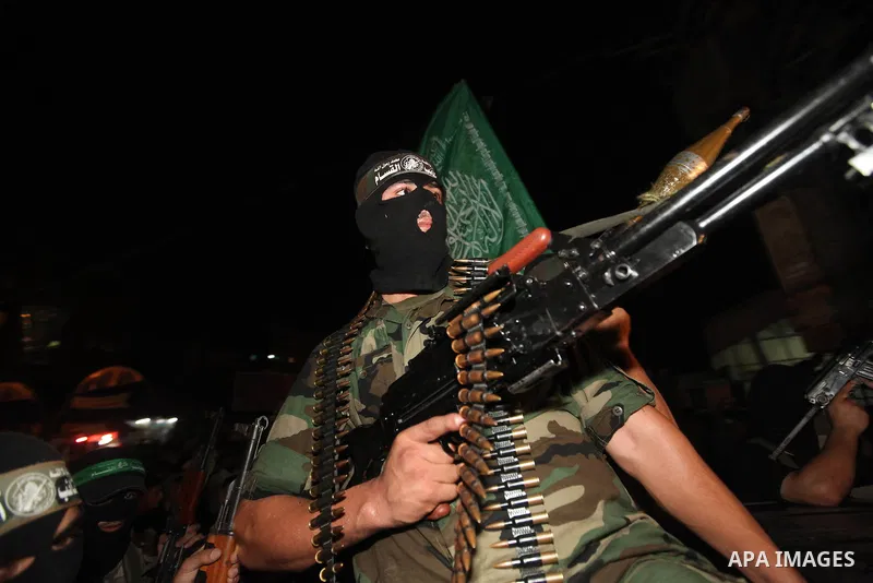 Masked Palestinian Hamas militants celebrate the announcement of a prisoner swap deal with Israel, in the Jebaliya refugee camp northern Gaza Strip, Tuesday, Oct. 11, 2011. Israeli and Hamas have reached a deal to free c...