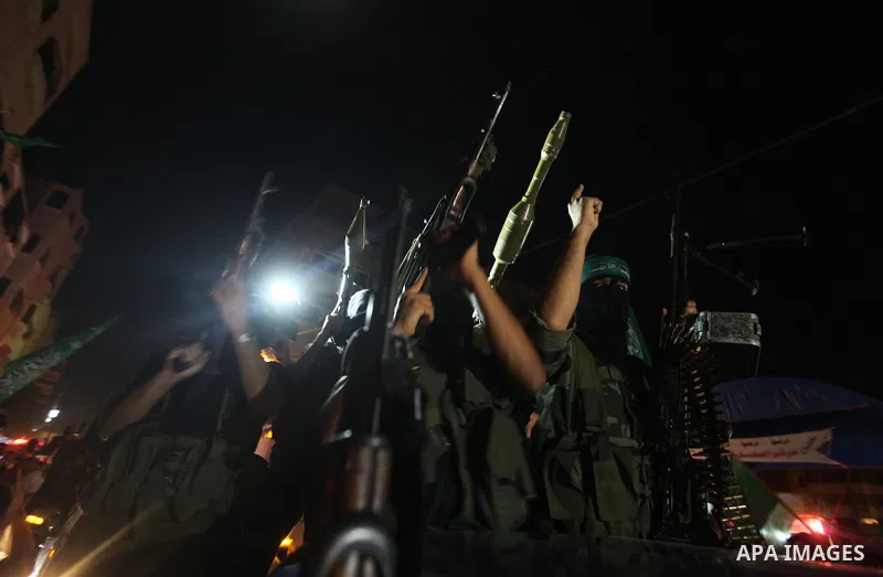 Masked Palestinian Hamas militants celebrate the announcement of a prisoner swap deal with Israel, in the Jebaliya refugee camp northern Gaza Strip, Tuesday, Oct. 11, 2011. Israeli and Hamas have reached a deal to free c...