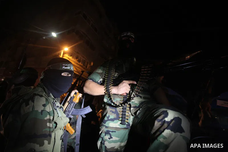 Masked Palestinian Hamas militants celebrate the announcement of a prisoner swap deal with Israel, in the Jebaliya refugee camp northern Gaza Strip, Tuesday, Oct. 11, 2011. Israeli and Hamas have reached a deal to free c...