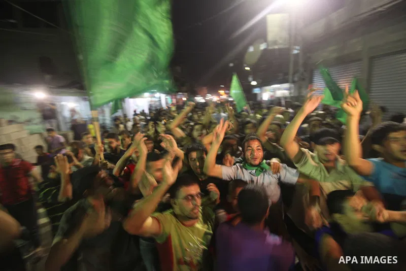 Palestinian Hamas supporters celebrate the announcement of a prisoner swap deal with Israel, in the Jebaliya refugee camp, northern Gaza Strip, Tuesday, Oct. 11, 2011. Israeli and Hamas have reached a deal to free captur...