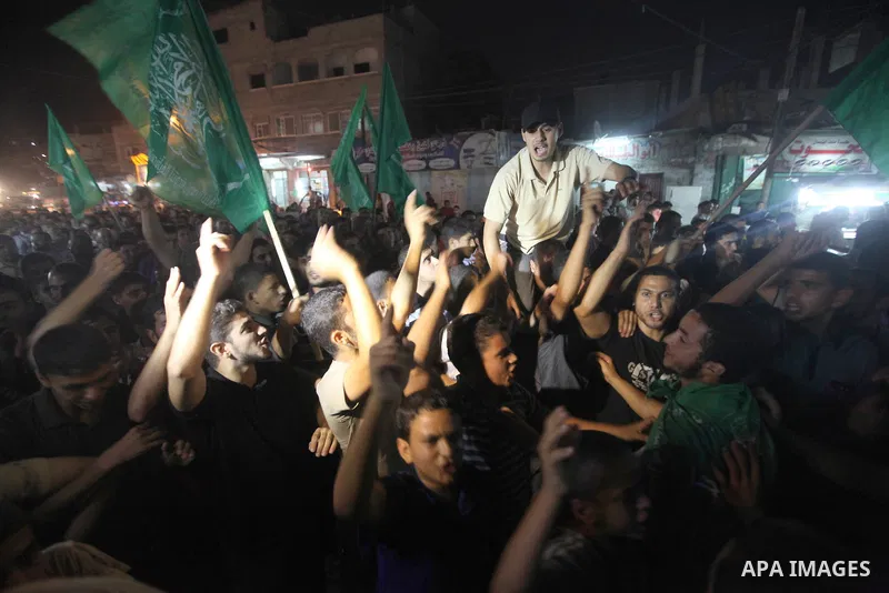 Palestinian Hamas supporters celebrate the announcement of a prisoner swap deal with Israel, in the Jebaliya refugee camp, northern Gaza Strip, Tuesday, Oct. 11, 2011. Israeli and Hamas have reached a deal to free captur...