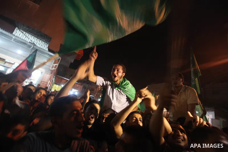 Palestinian Hamas supporters celebrate the announcement of a prisoner swap deal with Israel, in the Jebaliya refugee camp, northern Gaza Strip, Tuesday, Oct. 11, 2011. Israeli and Hamas have reached a deal to free captur...