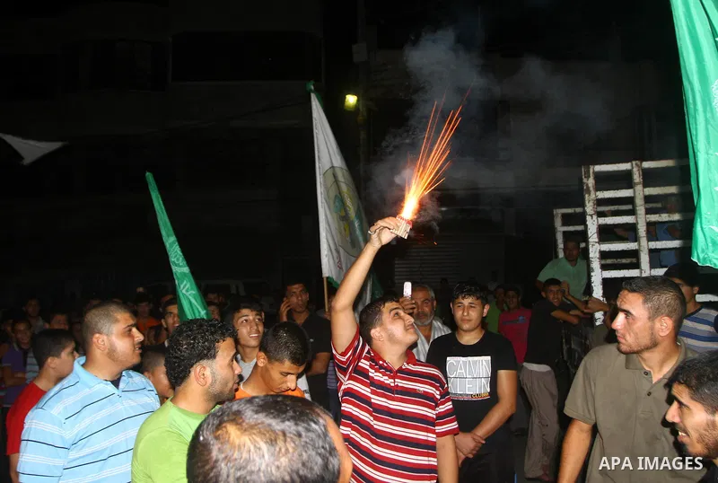 Palestinian members of Hamas celebrate a deal that will see Palestinian detainees freed in exchange for captured Israeli soldier Gilad Shalit on October 11, 2011, in Deir al-Balah in the central Gaza Strip. Shalit was ca...