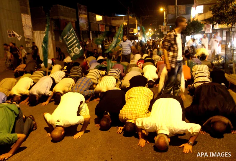 Palestinian members of Hamas celebrate a deal that will see Palestinian detainees freed in exchange for captured Israeli soldier Gilad Shalit on October 11, 2011, in Deir al-Balah in the central Gaza Strip. Shalit was ca...