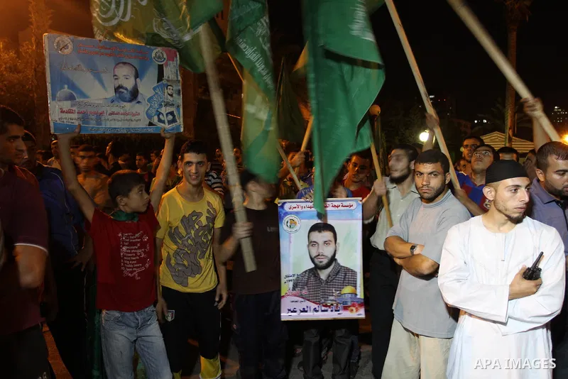 Palestinian members of Hamas celebrate a deal that will see Palestinian detainees freed in exchange for captured Israeli soldier Gilad Shalit on October 11, 2011, in Gaza City. Shalit was captured in 2006 by Hamas-allied...