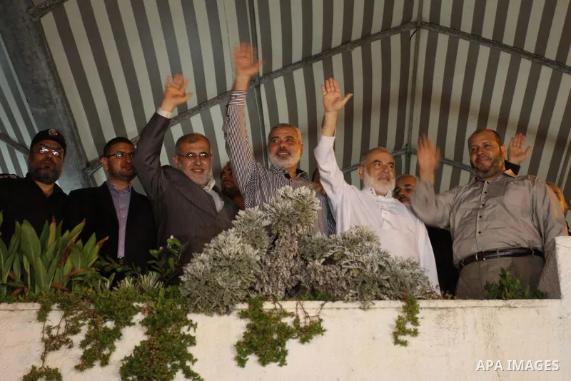 Hamas leaders waves to the crwed as they celebrate a deal that will see Palestinian detainees freed in exchange for captured Israeli soldier Gilad Shalit on October 11, 2011, in Gaza City. Shalit was captured in 2006 by...